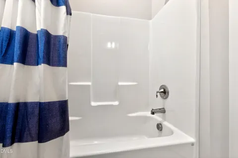 a bathroom with a bathtub and shower