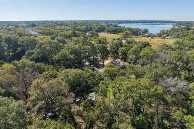 an aerial view of a houses with a yard