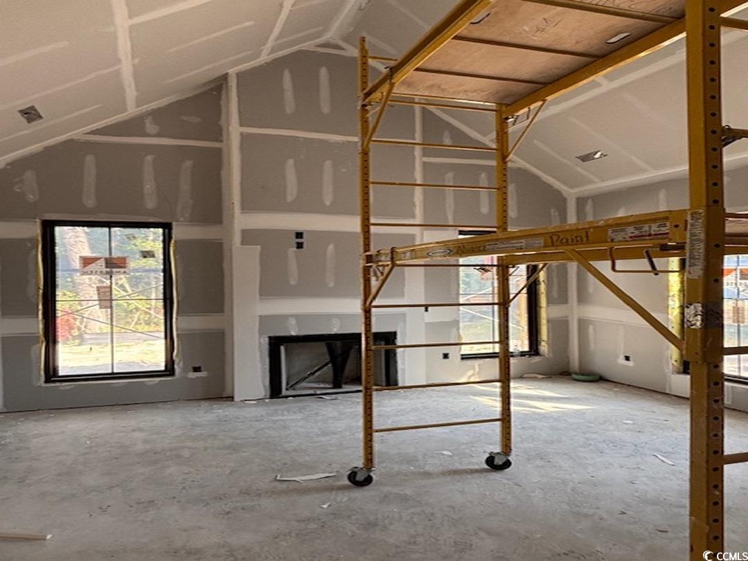 9413 Park Street Myrtle Beach, SC 29572 - Photo 22 of 40 Unfurnished living room with vaulted ceiling and a fireplace