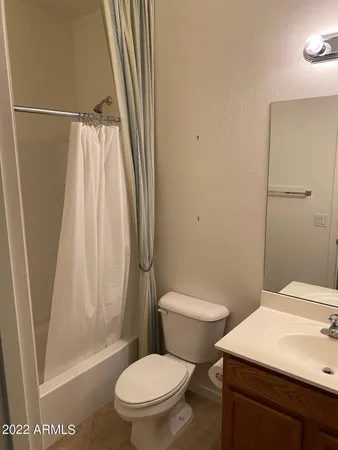 a white toilet sitting next to a bathroom sink
