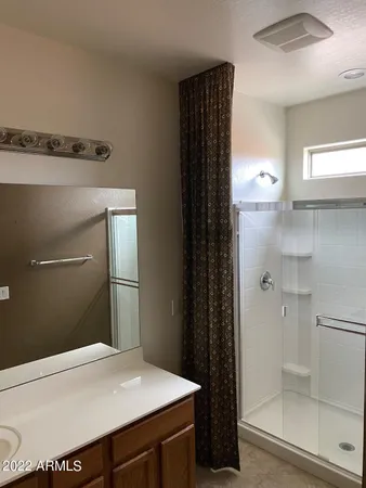 a bathroom with a shower and a sink