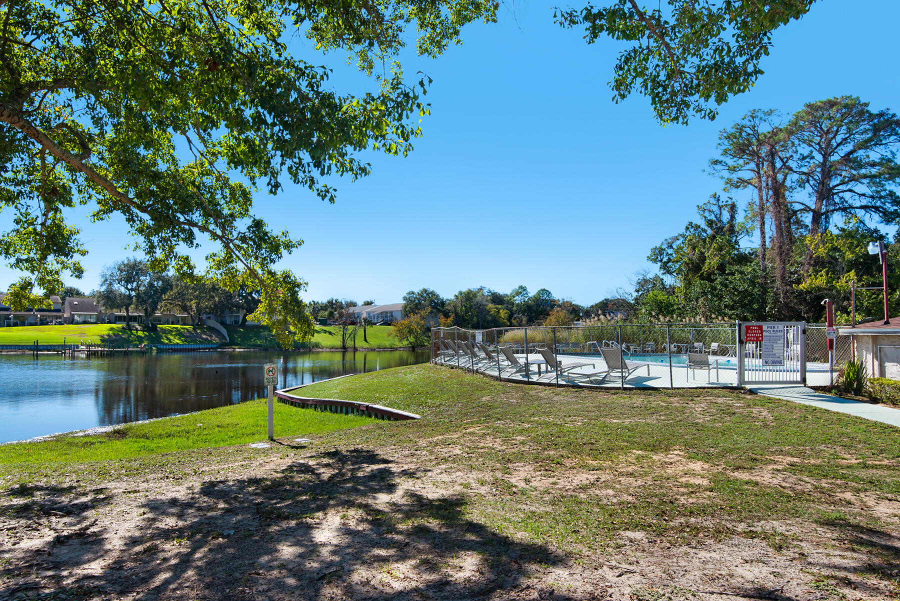 210 Pelham Road, Unit 215B Fort Walton Beach, FL 32547 - Photo 19 of 22 a view of a lake with a house