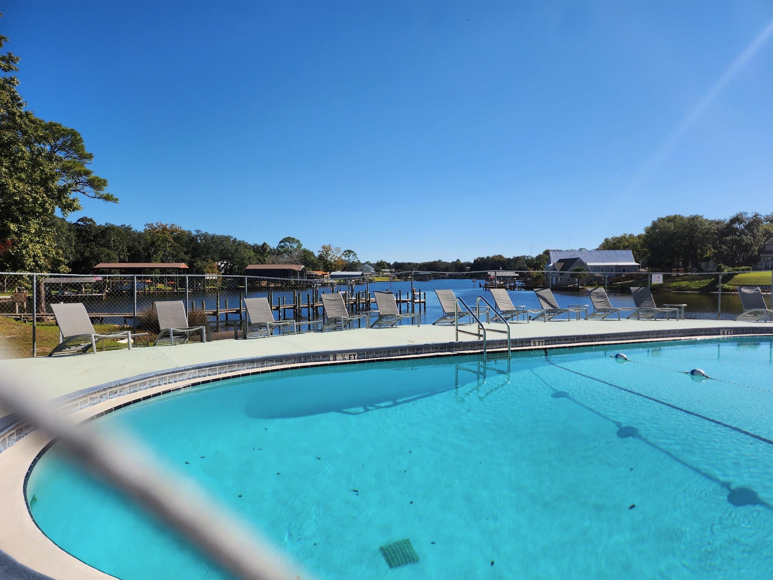 210 Pelham Road, Unit 215B Fort Walton Beach, FL 32547 - Photo 22 of 22 a view of a swimming pool with a chairs