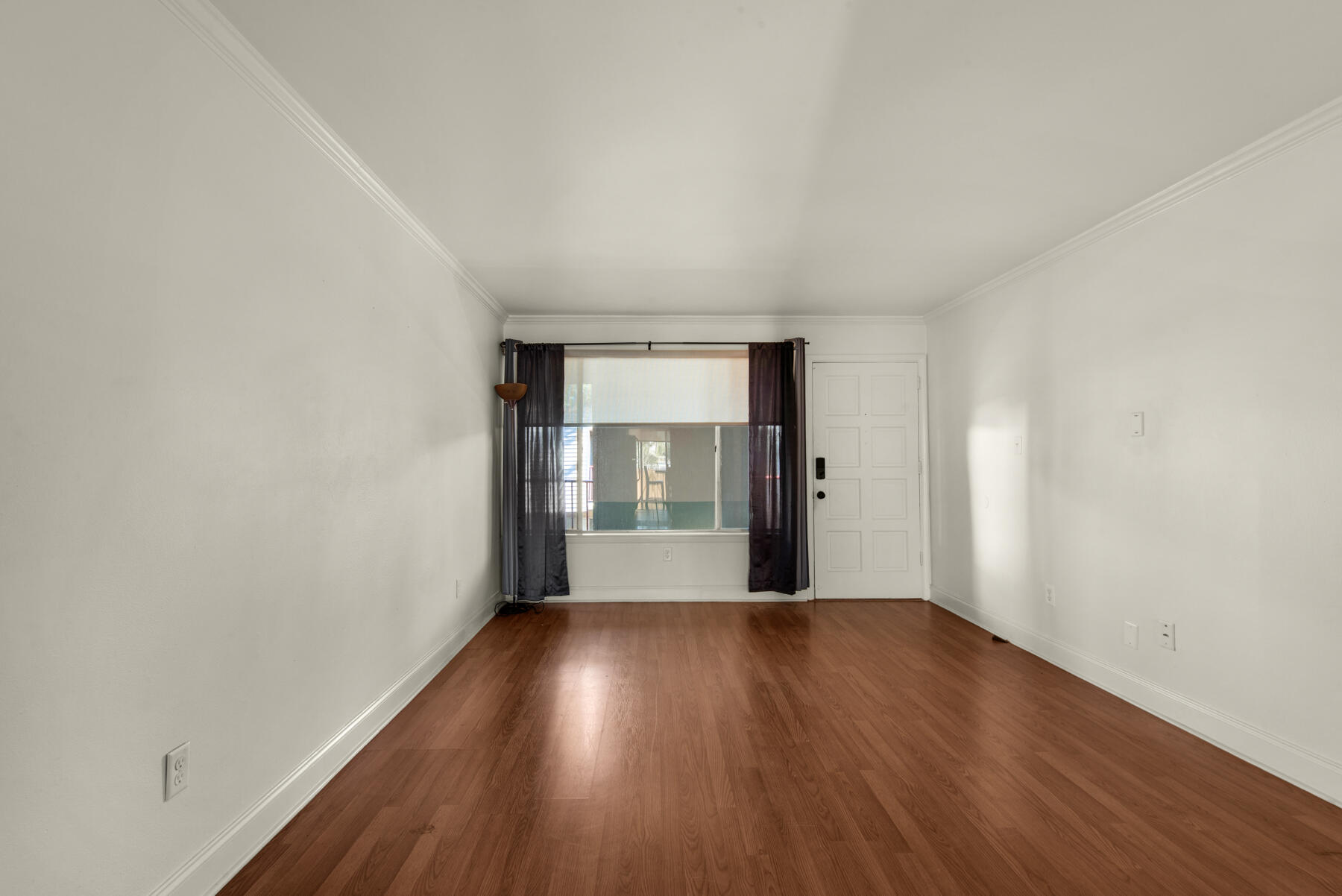 210 Pelham Road, Unit 215B Fort Walton Beach, FL 32547 - Photo 9 of 22 a view of an empty room with wooden floor and a window