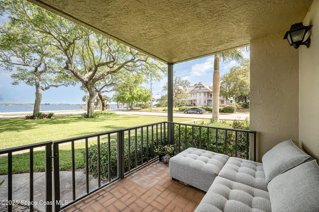 a balcony with furniture and garden view