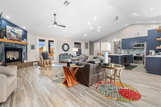 a bedroom with a bed a couch and a chandelier