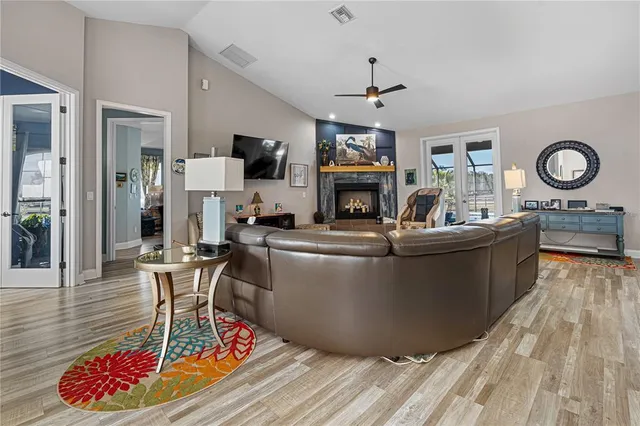 a living room with furniture a flat screen tv and kitchen view