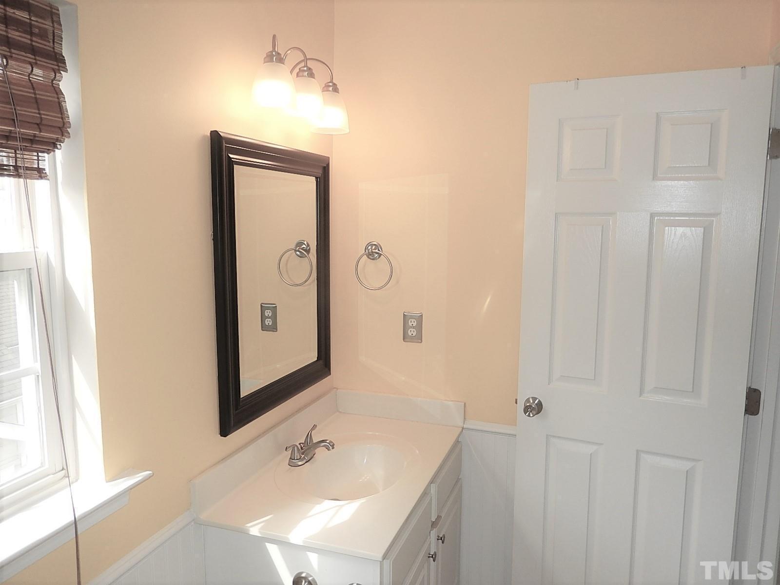 4717 Delta Ridge Court Raleigh, NC 27612 - Photo 25 of 30 a bathroom with a sink and a mirror
