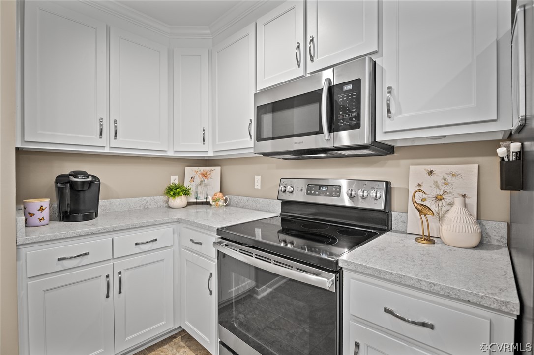 5303 Meadow Chase Road Midlothian, VA 23112 - Photo 15 of 49 a kitchen with white cabinets and stainless steel appliances