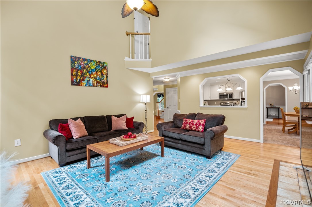 5303 Meadow Chase Road Midlothian, VA 23112 - Photo 21 of 49 a living room with furniture a rug and a chandelier