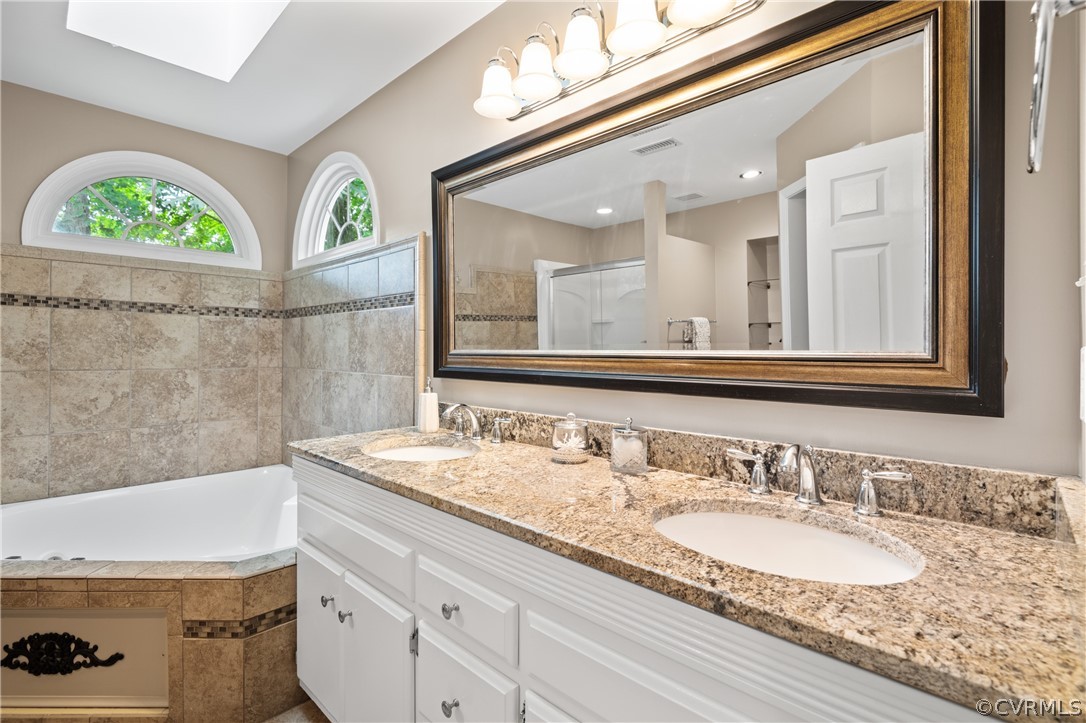 5303 Meadow Chase Road Midlothian, VA 23112 - Photo 34 of 49 a bathroom with a granite countertop bathtub a double vanity sink and a large mirror