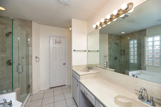 a bathroom with a sink double vanity and shower
