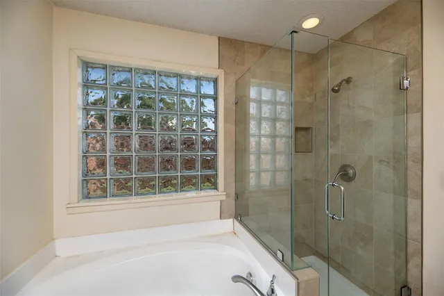 a bathroom with a bathtub and a shower