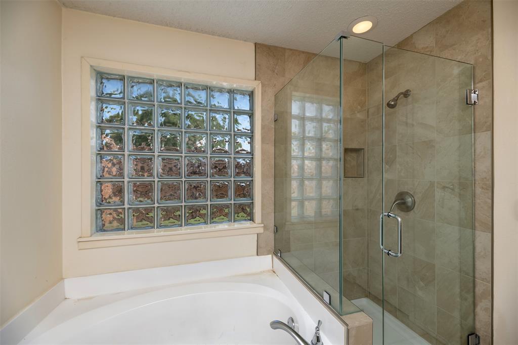 1410 Brookside Drive Allen, TX 75002 - Photo 13 of 38 a bathroom with a bathtub and a shower