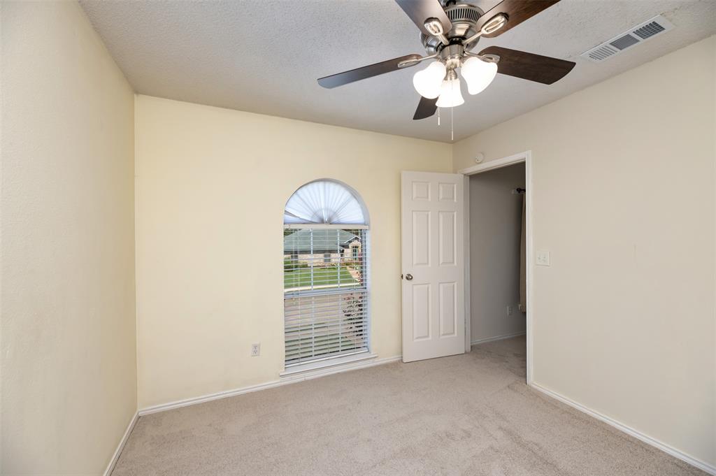 1410 Brookside Drive Allen, TX 75002 - Photo 21 of 38 an empty room with fan and entrance