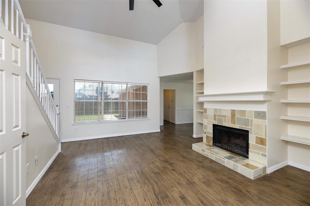 1410 Brookside Drive Allen, TX 75002 - Photo 4 of 38 a view of an empty room with wooden floor fireplace and a window