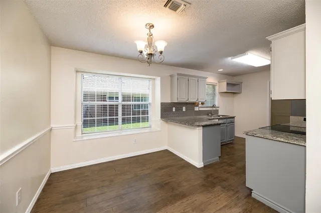 a kitchen with granite countertop counter top space and stainless steel appliances