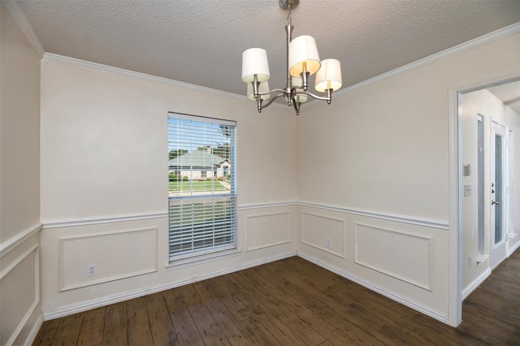 1410 Brookside Drive Allen, TX 75002 - Photo 9 of 38 a view of a hallway with wooden floor and chandelier