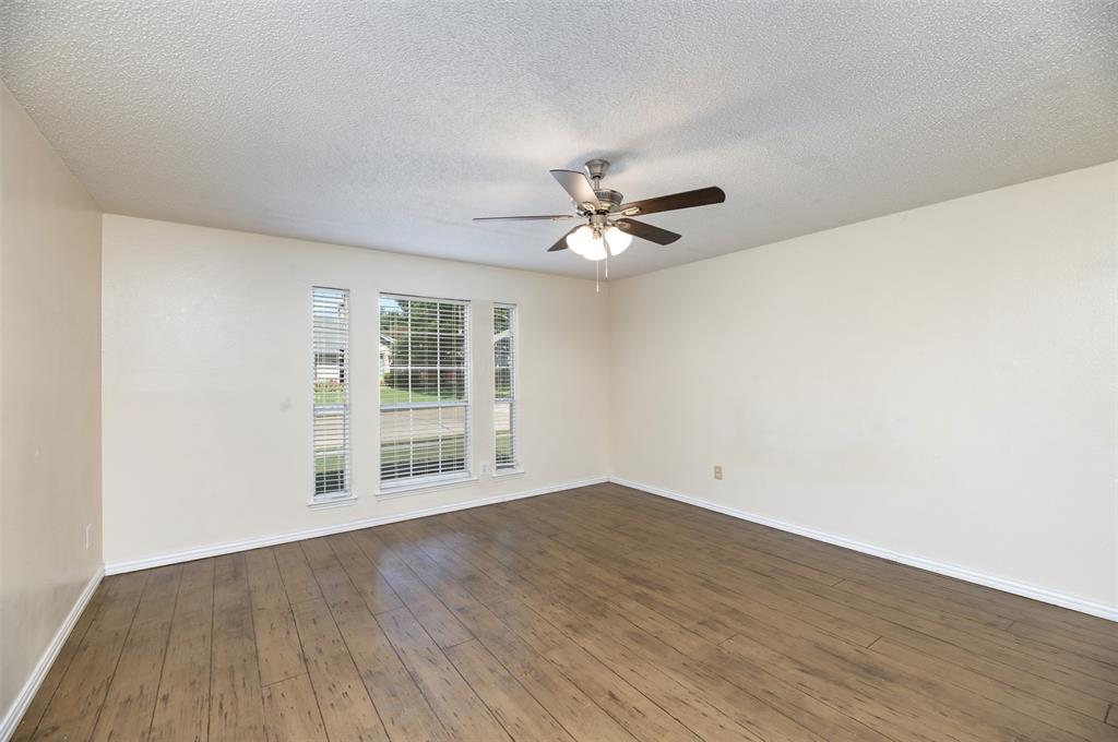 1410 Brookside Drive Allen, TX 75002 - Photo 10 of 38 a view of an empty room with wooden floor and a window