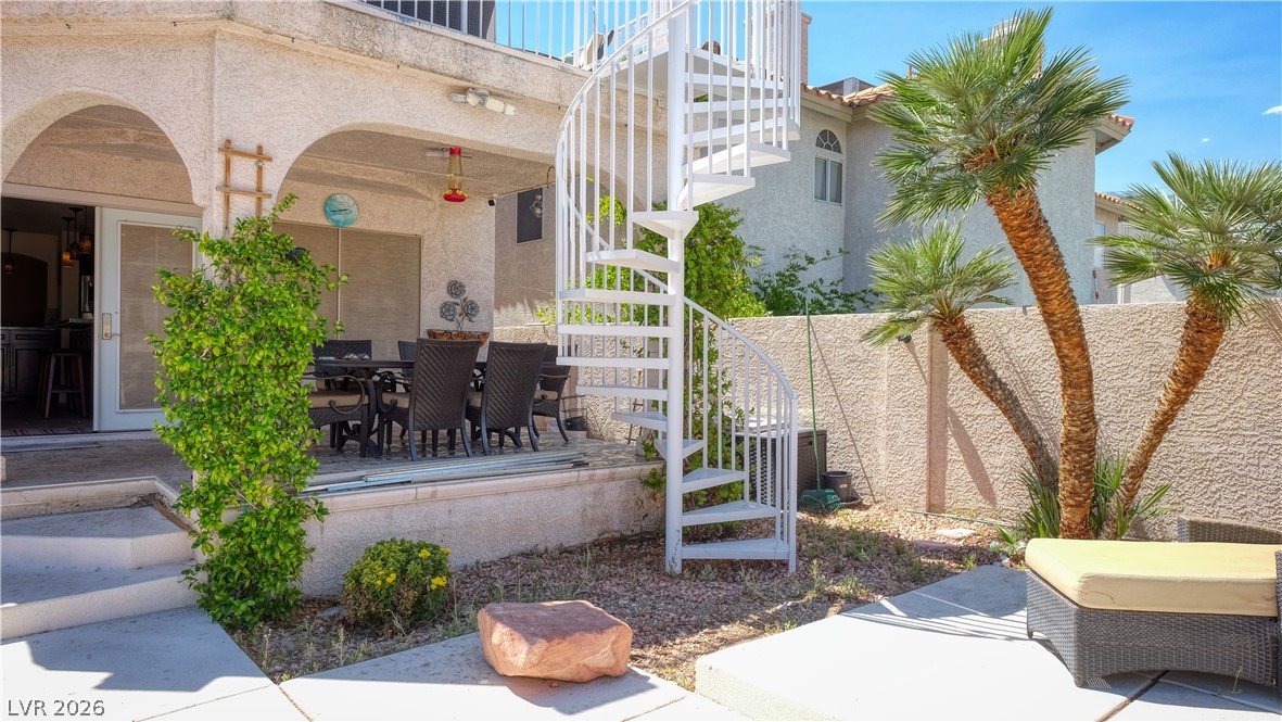 3704 North Campbell Road Las Vegas, NV 89129 - Photo 18 of 38 An inviting outdoor living space features an elegant spiral staircase leading to an upper level.