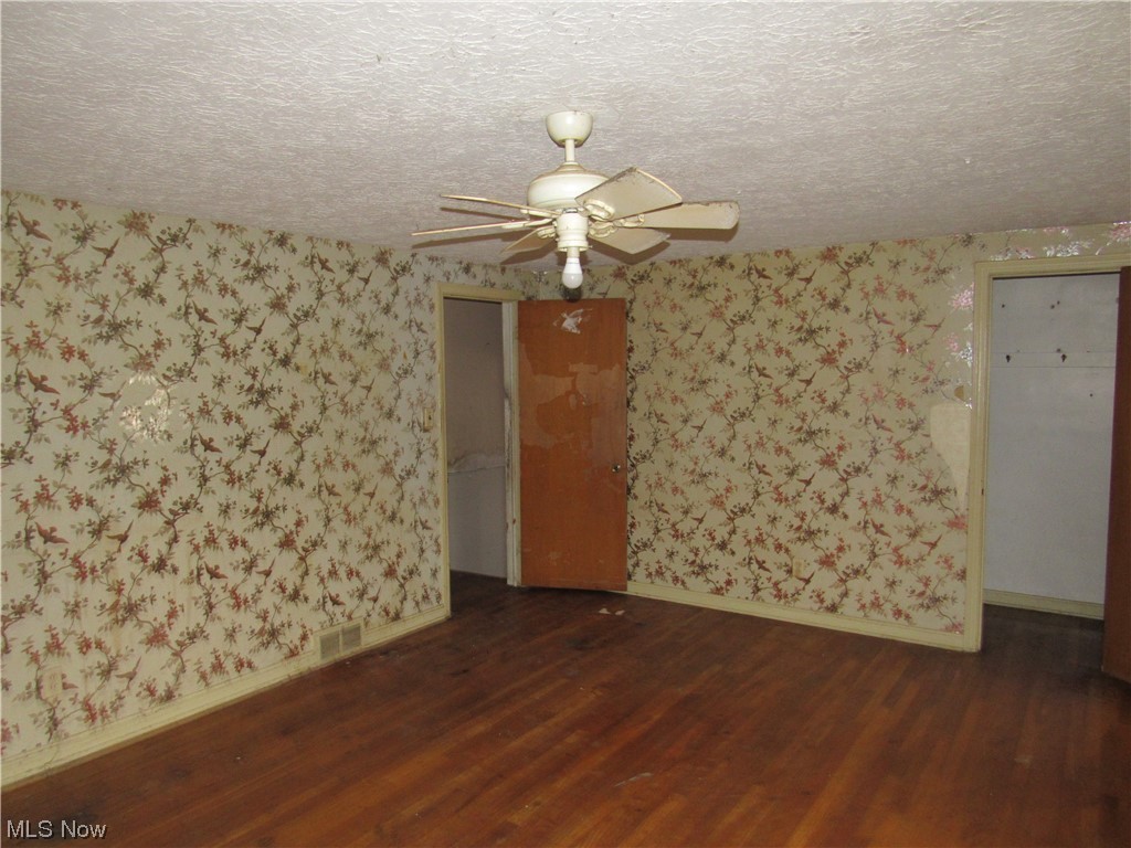 2350 North Taylor Road Cleveland, OH 44112 - Photo 20 of 24 Spare room with ceiling fan, a textured ceiling, and dark hardwood / wood-style flooring