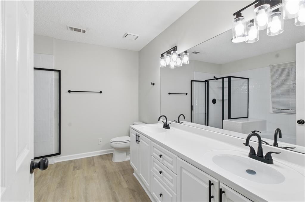 2110 Meadow View Court Grayson, GA 30017 - Photo 34 of 50 a bathroom with a double vanity sink mirror and toilet