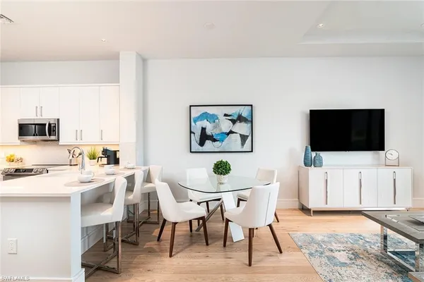 a view of a dining room with furniture and wooden floor