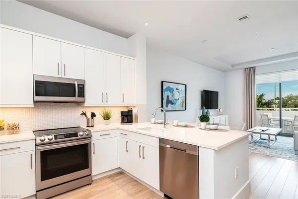 a kitchen with a sink stove and microwave
