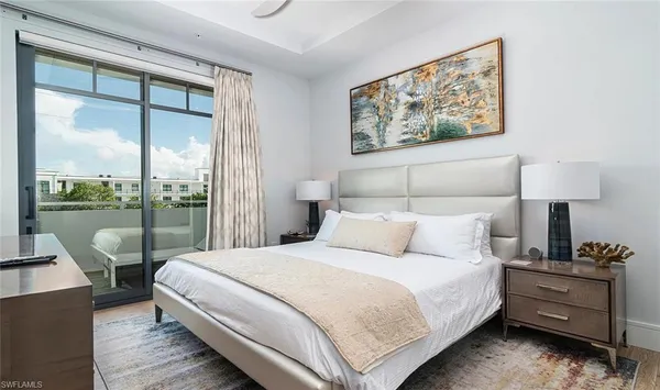 a bedroom with a bed and a large window