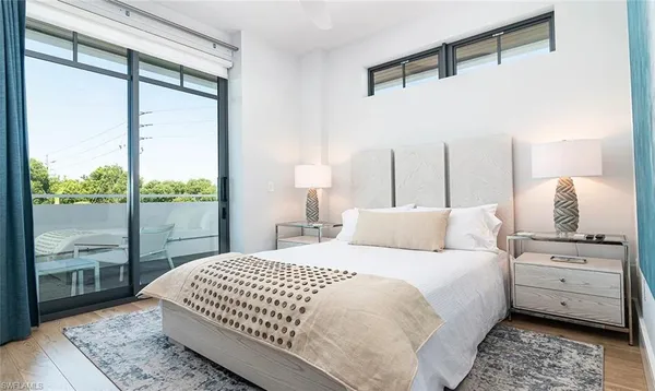 a bedroom with a large bed and a window