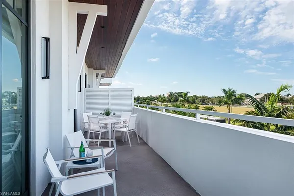 a view of a balcony with chairs