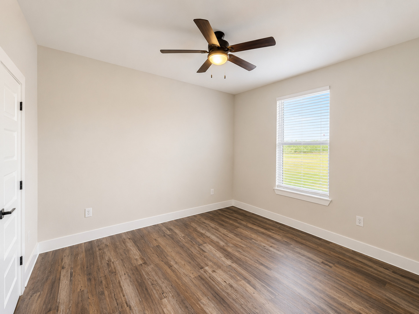 488 County Road 468 Elgin, TX 78621 - Photo 10 of 12 A well-proportioned bedroom with rich wood-look flooring and a window offering expansive views.
