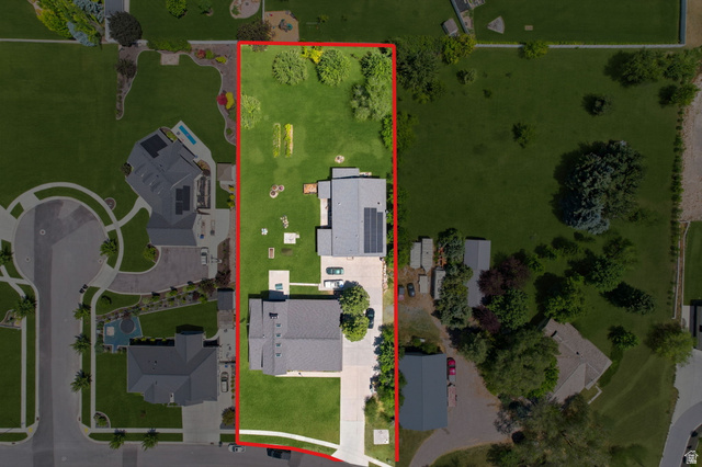 580 North 300 East Logan, UT 84321 - Photo 4 of 74 Expansive property featuring two distinct structures, a substantial grassy yard, and mature trees