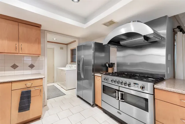 a kitchen with stainless steel appliances granite countertop a stove and a sink