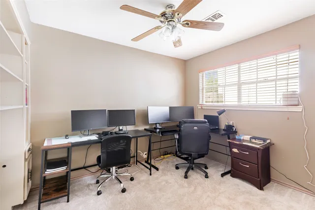 a bedroom with a bed a dresser and chair