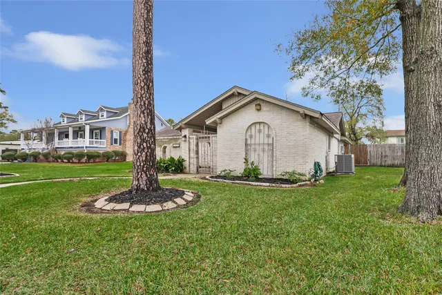 a front view of a house with a yard and trees