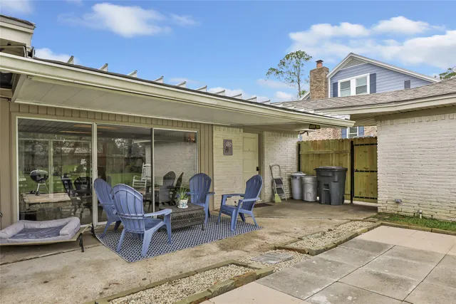 a front view of a house with outdoor seating