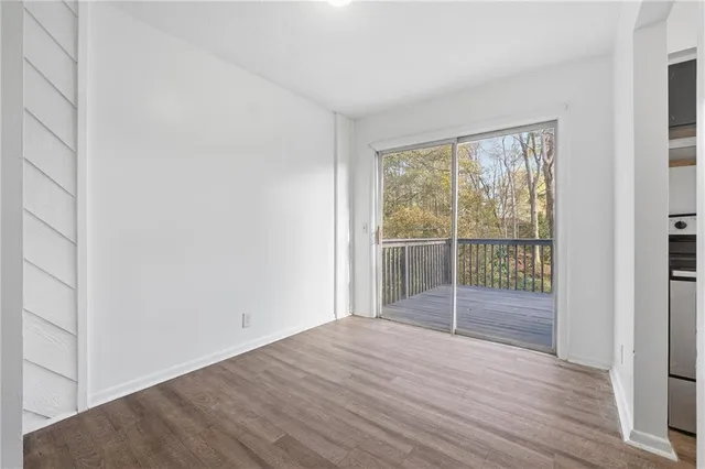 a view of a room with wooden floor and windows