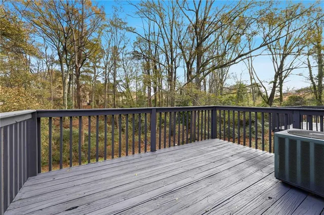 a balcony with wooden floor and fence