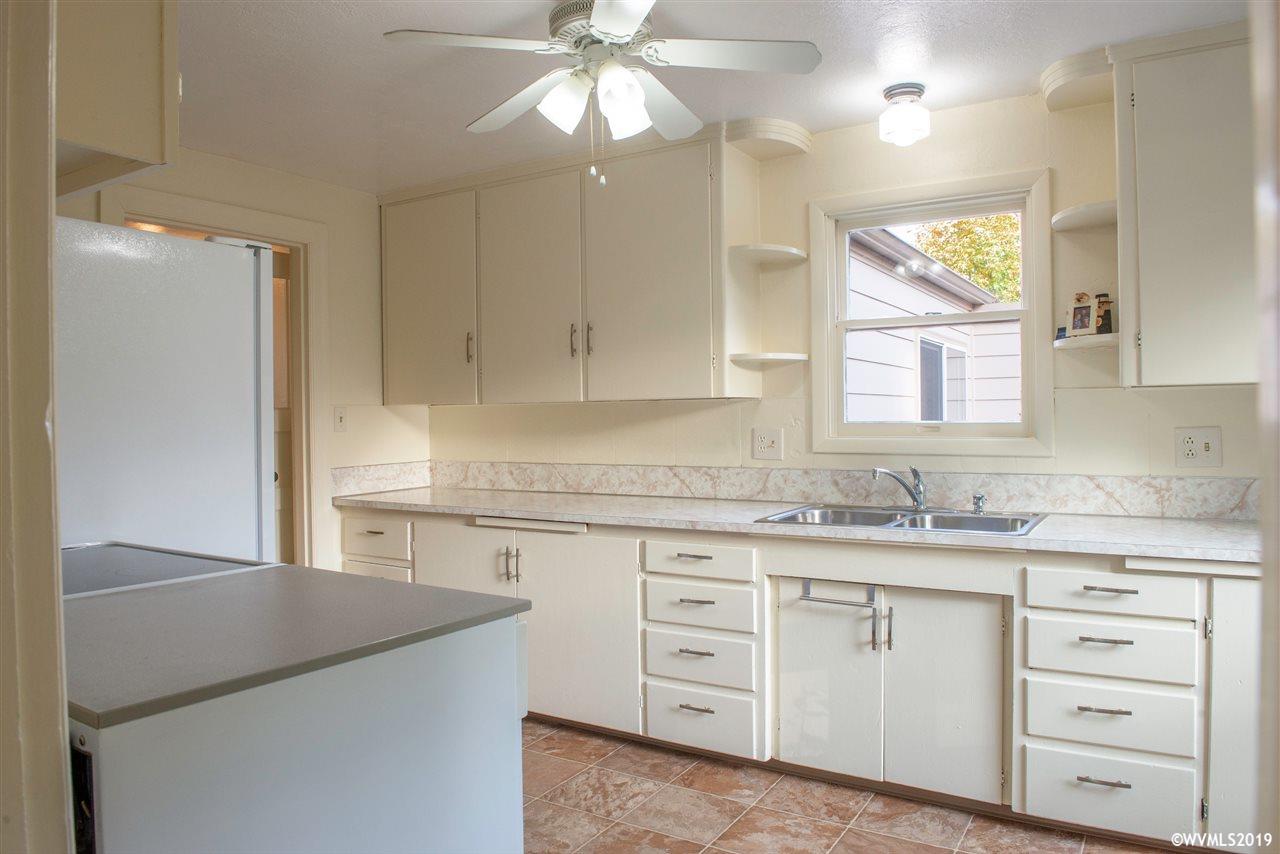 4831 Bailey Road Northeast Keizer, OR 97303 - Photo 6 of 19 a kitchen with cabinets appliances a sink and a window