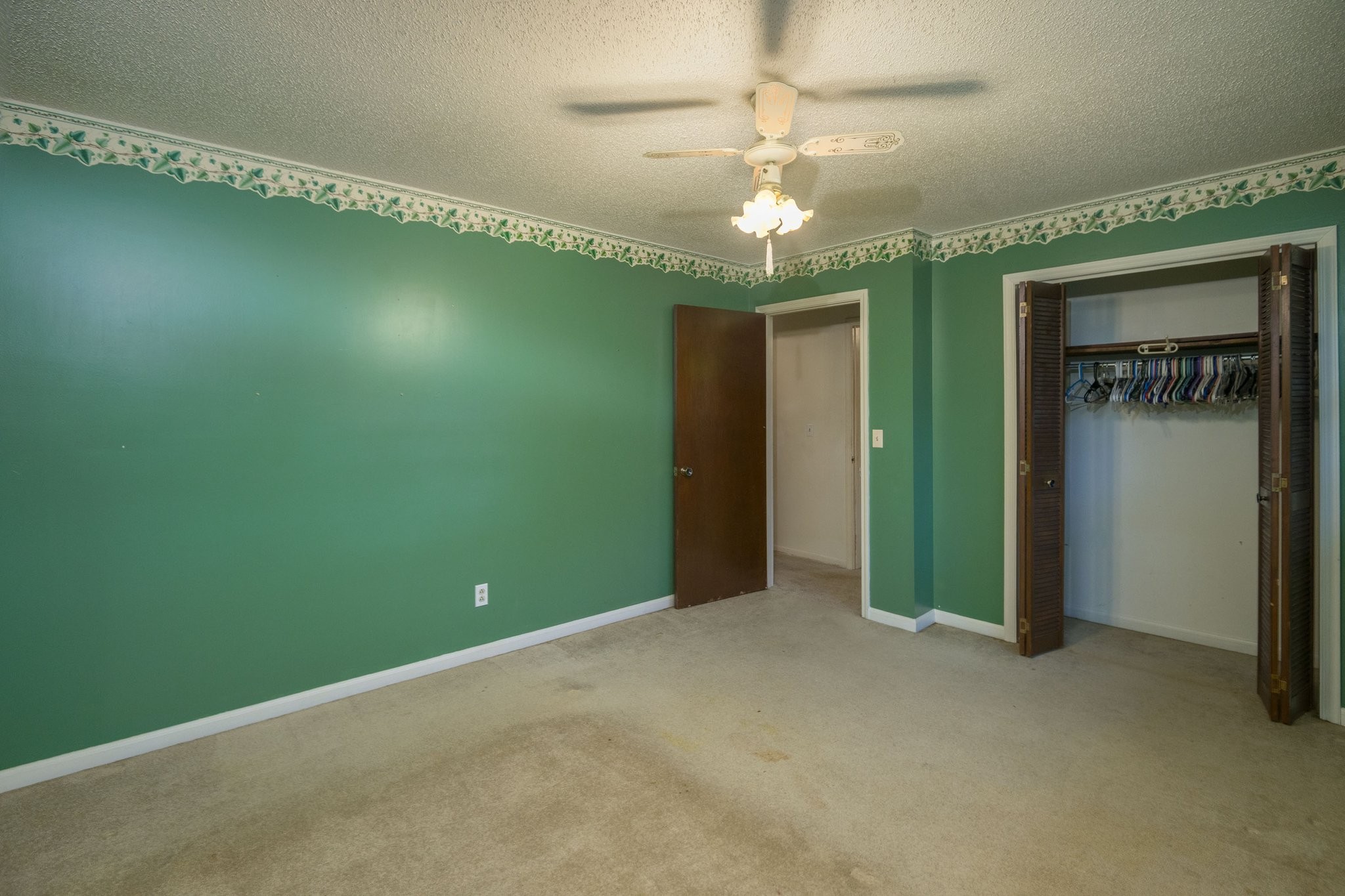 808 Windmere Drive Lebanon, TN 37090 - Photo 54 of 82 an empty room with a chandelier fan and a large window