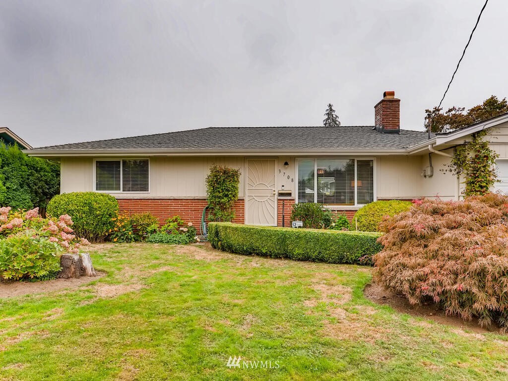 3708 Northeast 10th Street Renton, WA 98056 - Photo 1 of 28 a front view of a house with garden