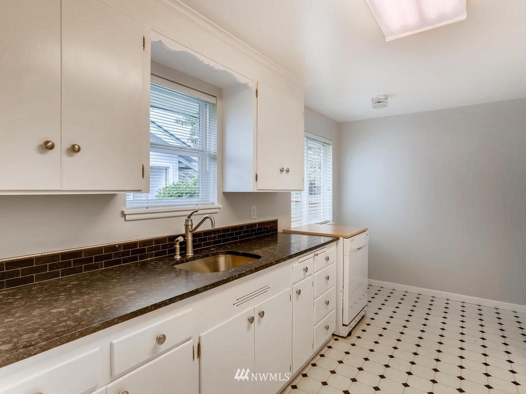 3708 Northeast 10th Street Renton, WA 98056 - Photo 8 of 28 a kitchen with granite countertop a sink a stove and cabinets