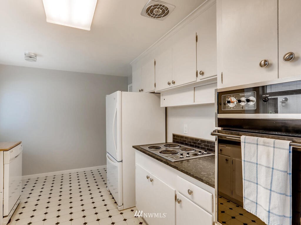 3708 Northeast 10th Street Renton, WA 98056 - Photo 9 of 28 a kitchen with a stove a refrigerator and cabinets