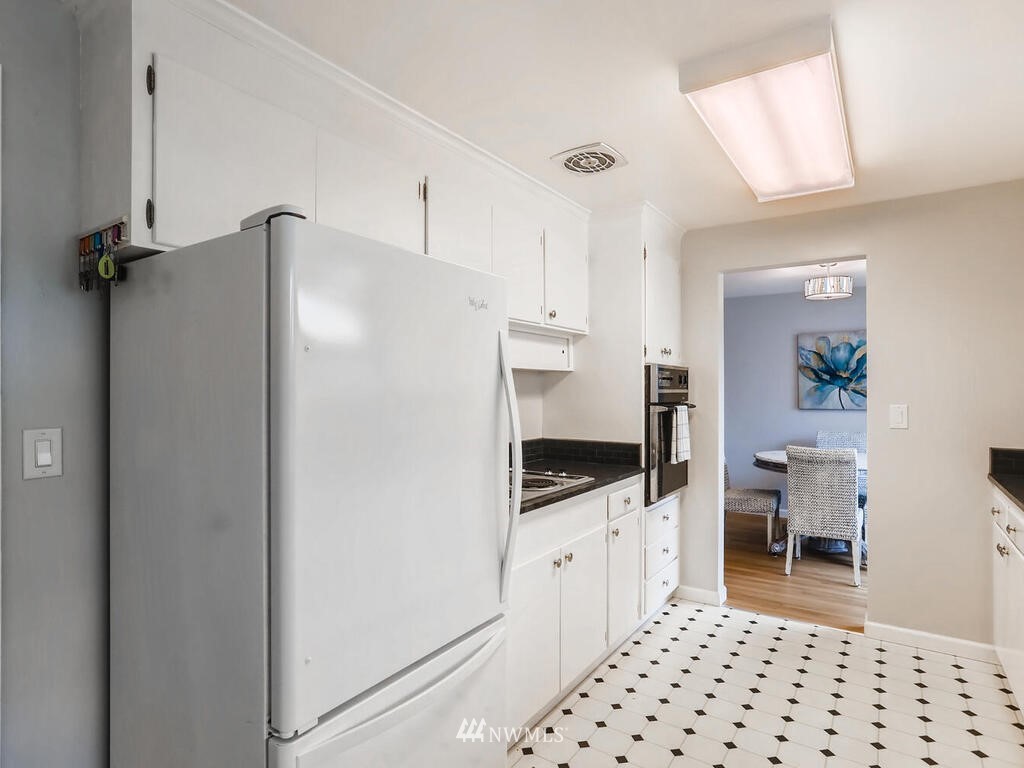 3708 Northeast 10th Street Renton, WA 98056 - Photo 10 of 28 a kitchen with granite countertop a refrigerator and a stove top oven