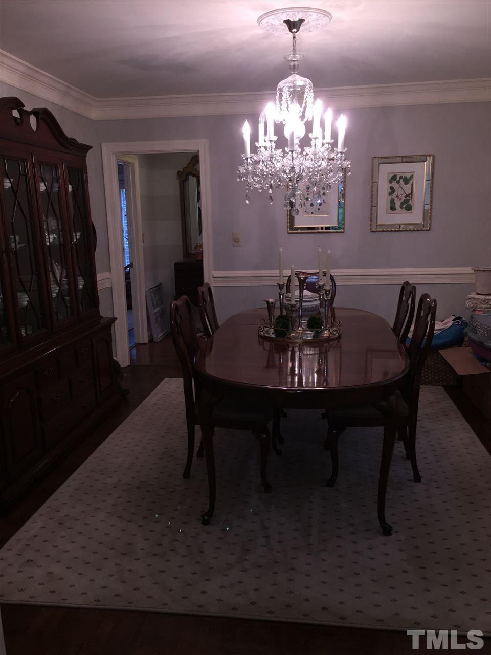 910 Blenheim Drive Raleigh, NC 27612 - Photo 5 of 11 a view of a dining room with furniture and chandelier