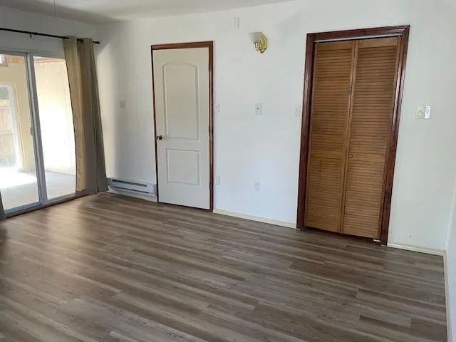 a kitchen with granite countertop white cabinets and stainless steel appliances