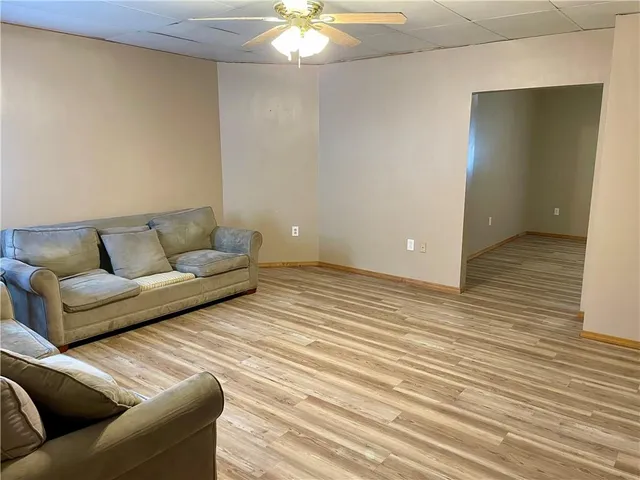 a living room with furniture and a dining table