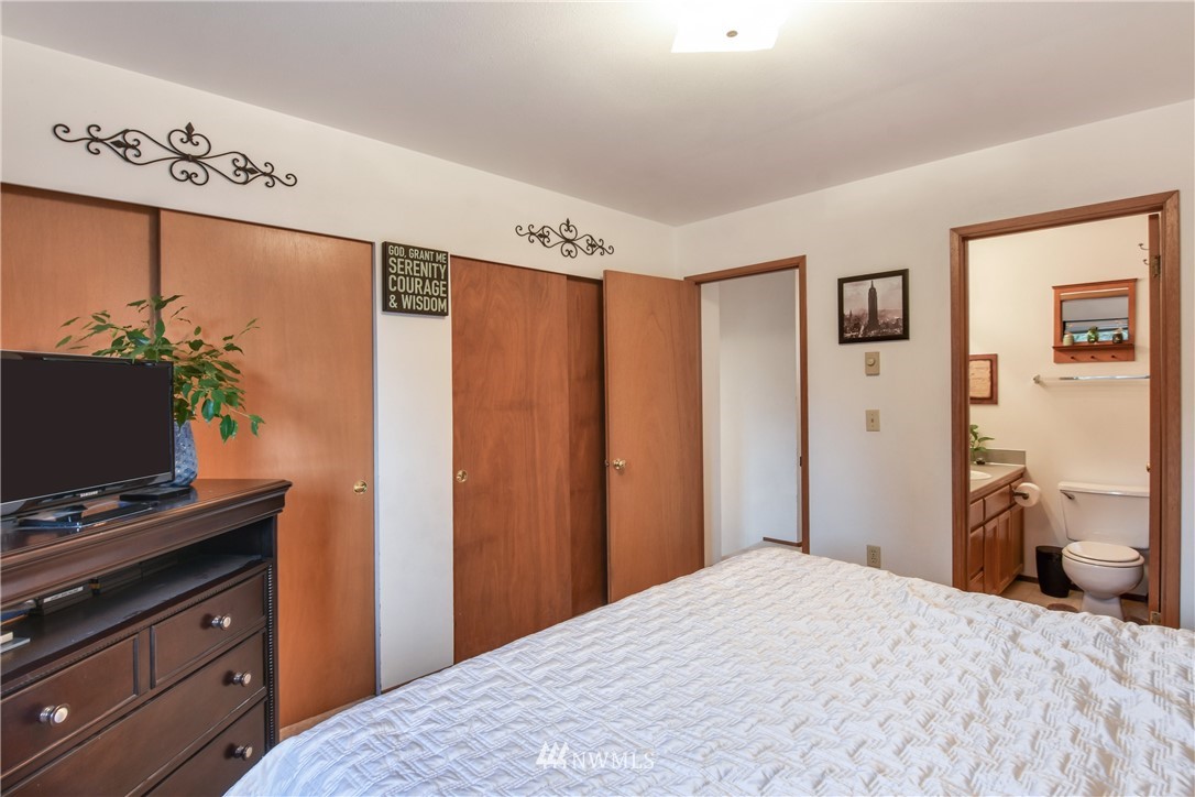12017 Alexander Road Everett, WA 98204 - Photo 22 of 25 a bedroom with a bed and a flat screen tv
