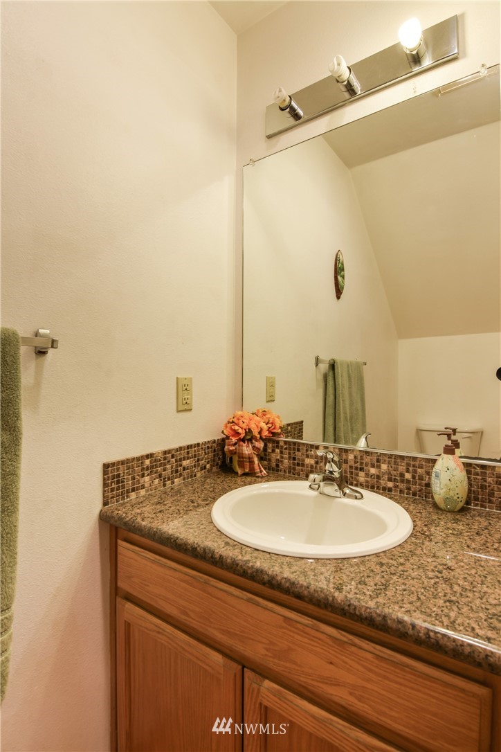 12017 Alexander Road Everett, WA 98204 - Photo 8 of 25 a bathroom with a granite countertop sink and a mirror
